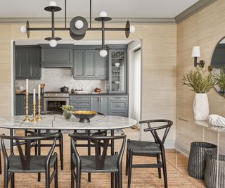 Black dining chairs and light, marble top table