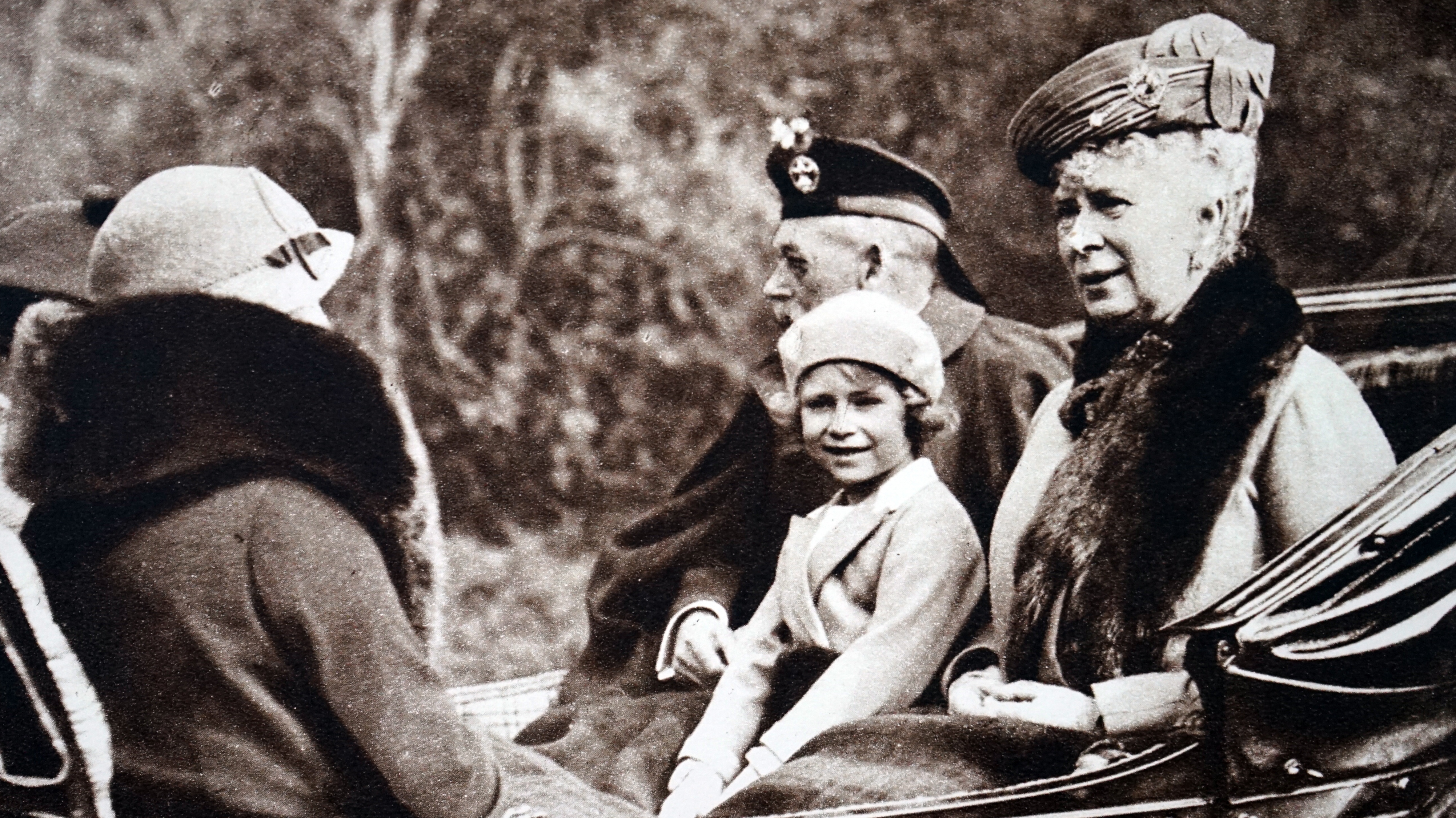 Photograph of Princess Elizabeth with her grandparents, Queen Mary of Teck and King George V. Also pictured is her mother Elizabeth