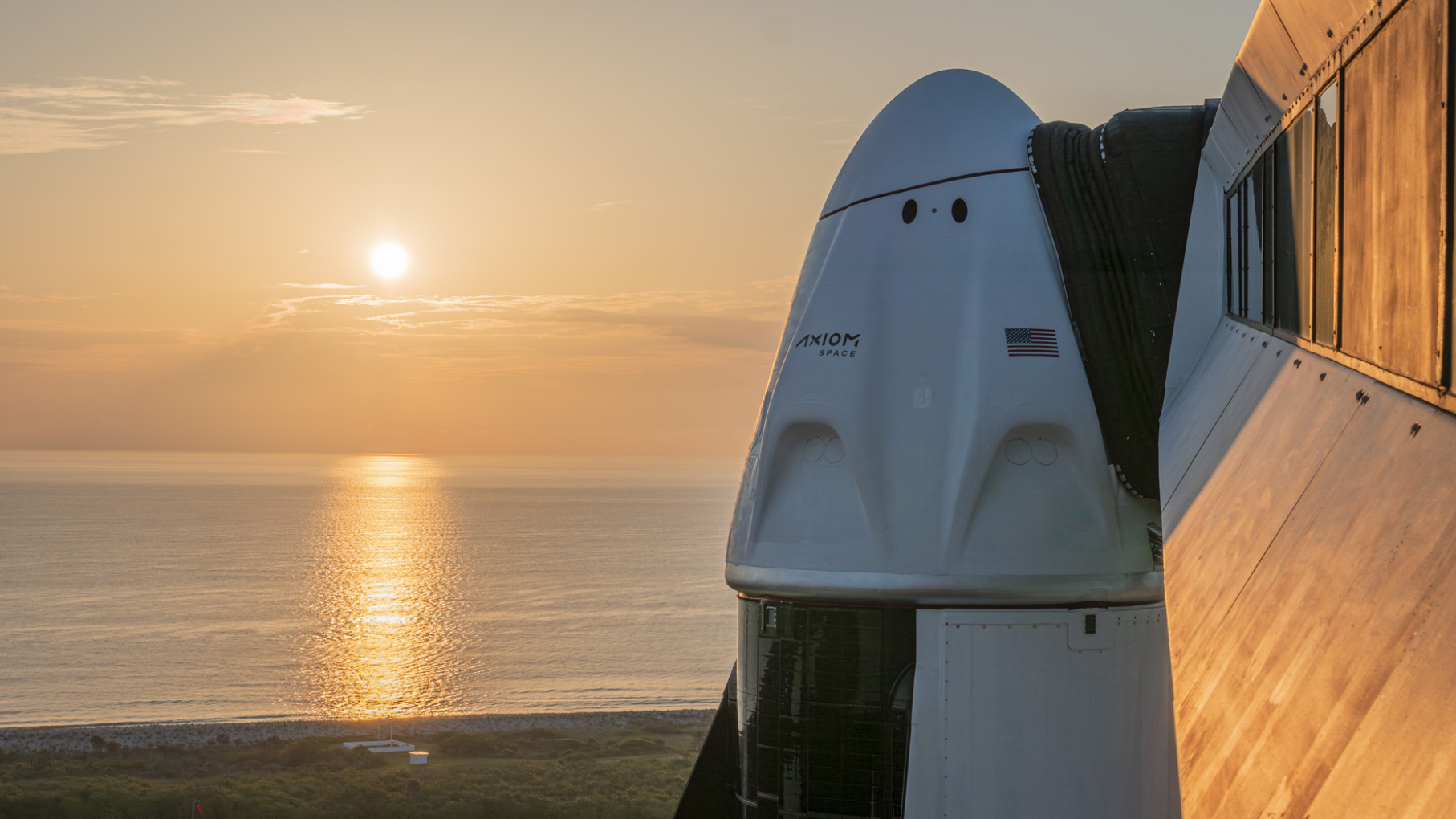 the sun rising behind Axiom Space's SpaceX Dragon capsule