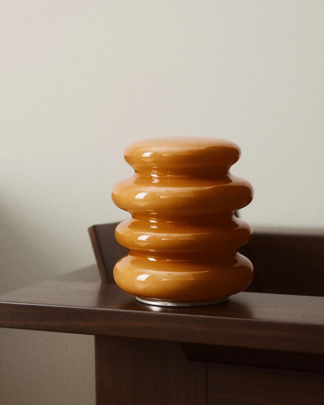 Rechargeable Table Lamp in orange, wavy silhouette.