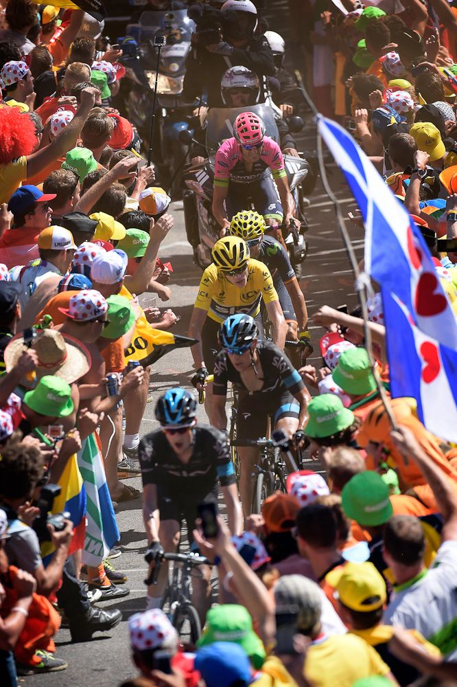 team Sky lead Chris Froome through the crowd on Alpe d'Huez
