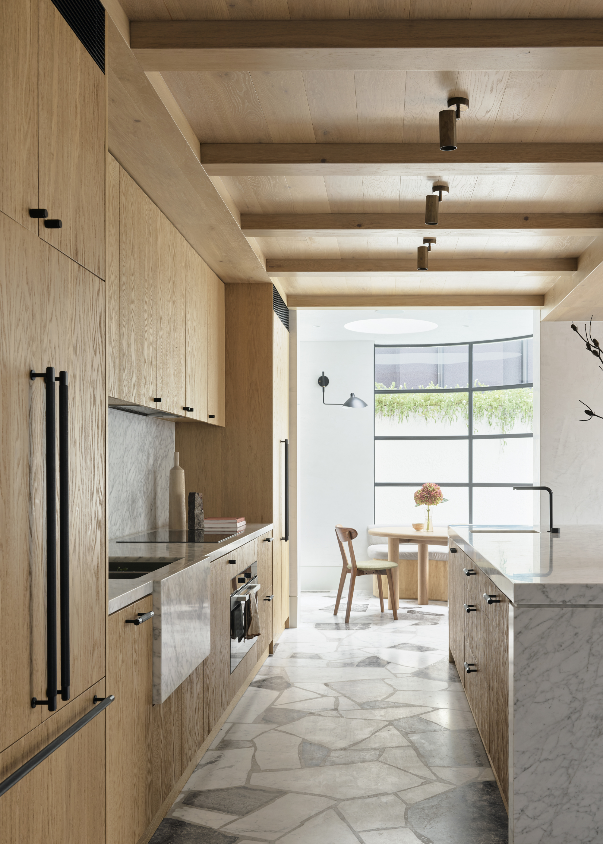 A kitchen with cabinets that go all the way to the ceiling
