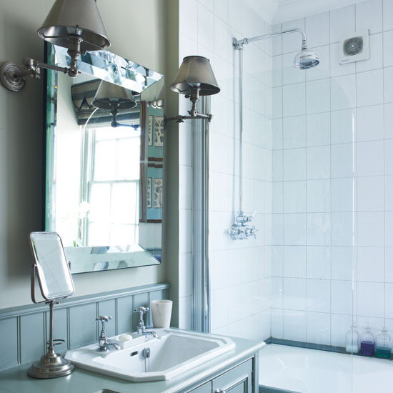 White bathroom with mirror on the wall