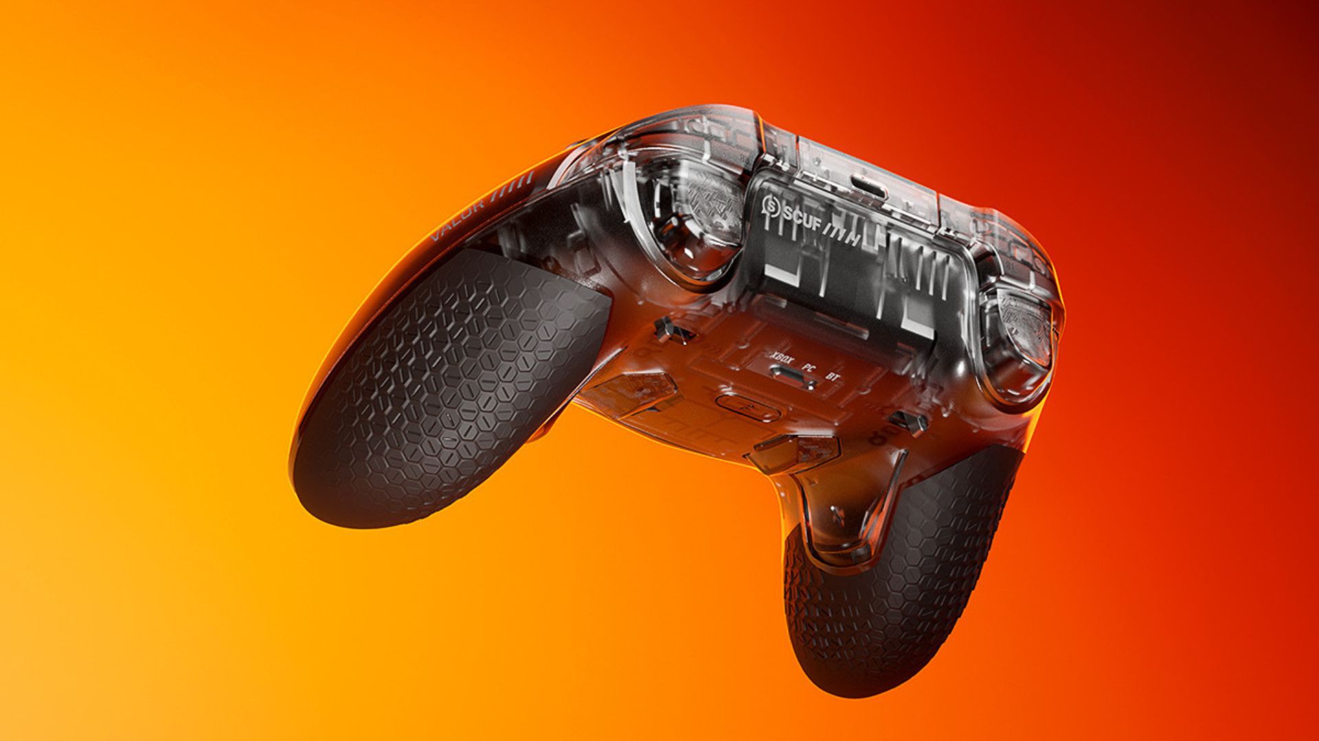 A Scuf Valor Pro Wireless reveal image showing the back of the controller on an orange background