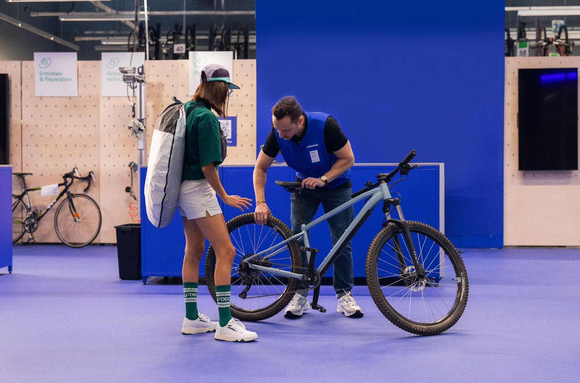 Female cyclist trading in her bike at a Decathlon store as part of the brand's Buyback program