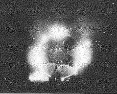 A circular machine sits at the center of a gray image in a background