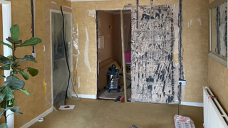 Laura's room with plastic zip up door cover on a door to the left