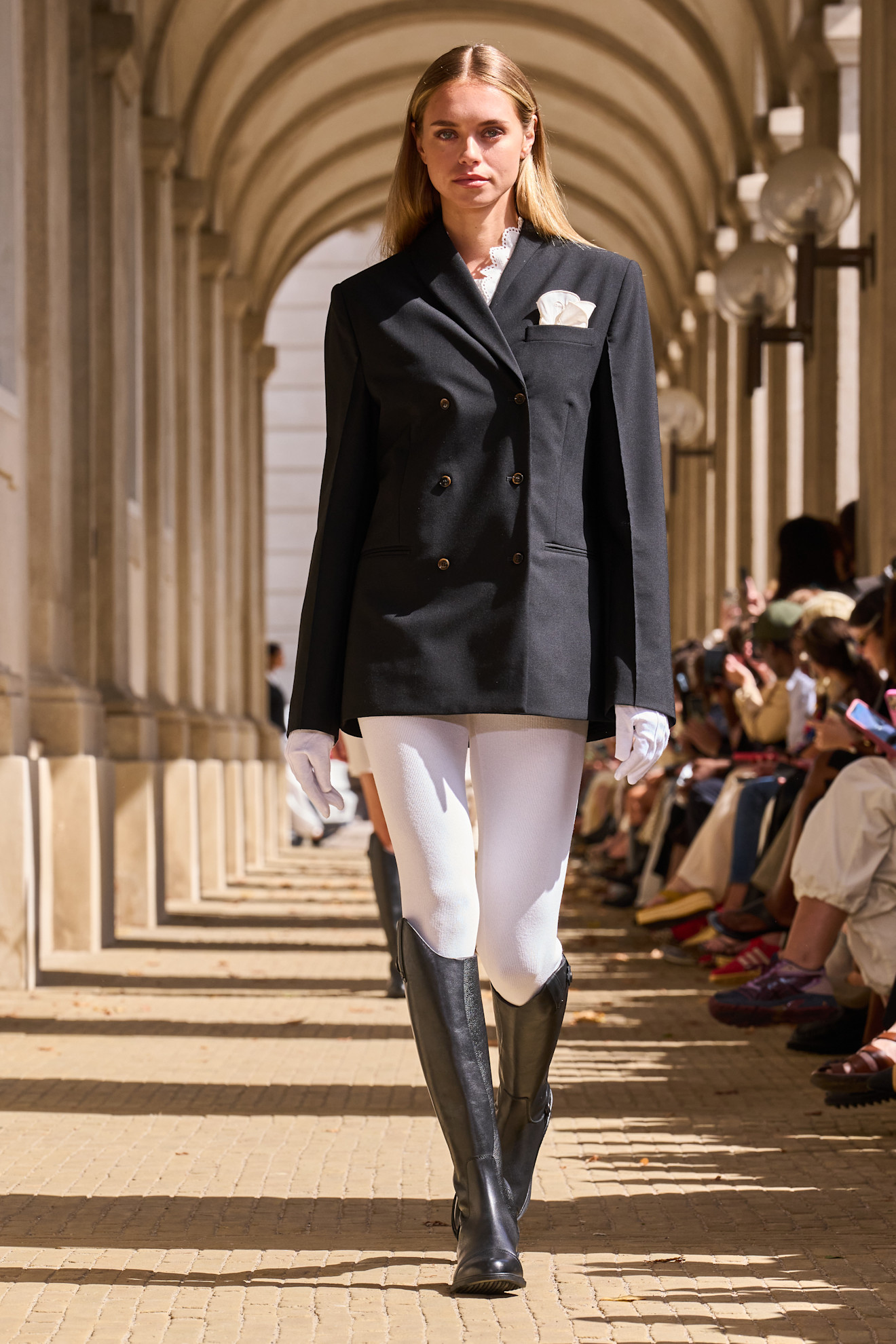 The Garment model wearing riding boots.