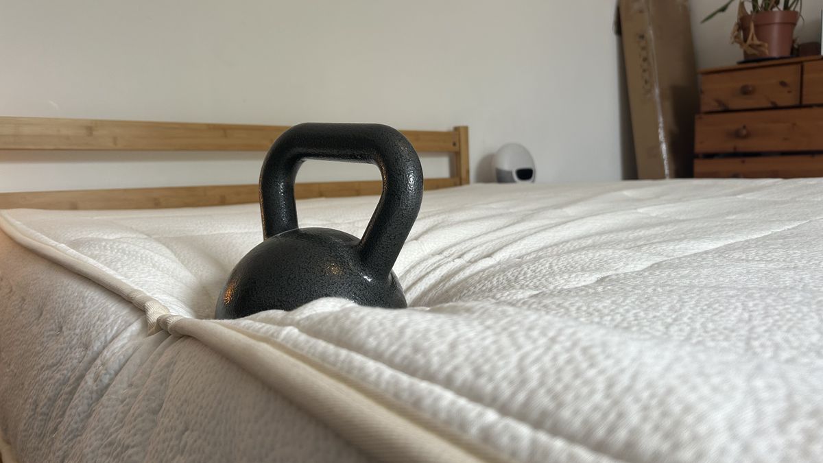 A weight on the edge of the Awara Classic mattress to test edge support