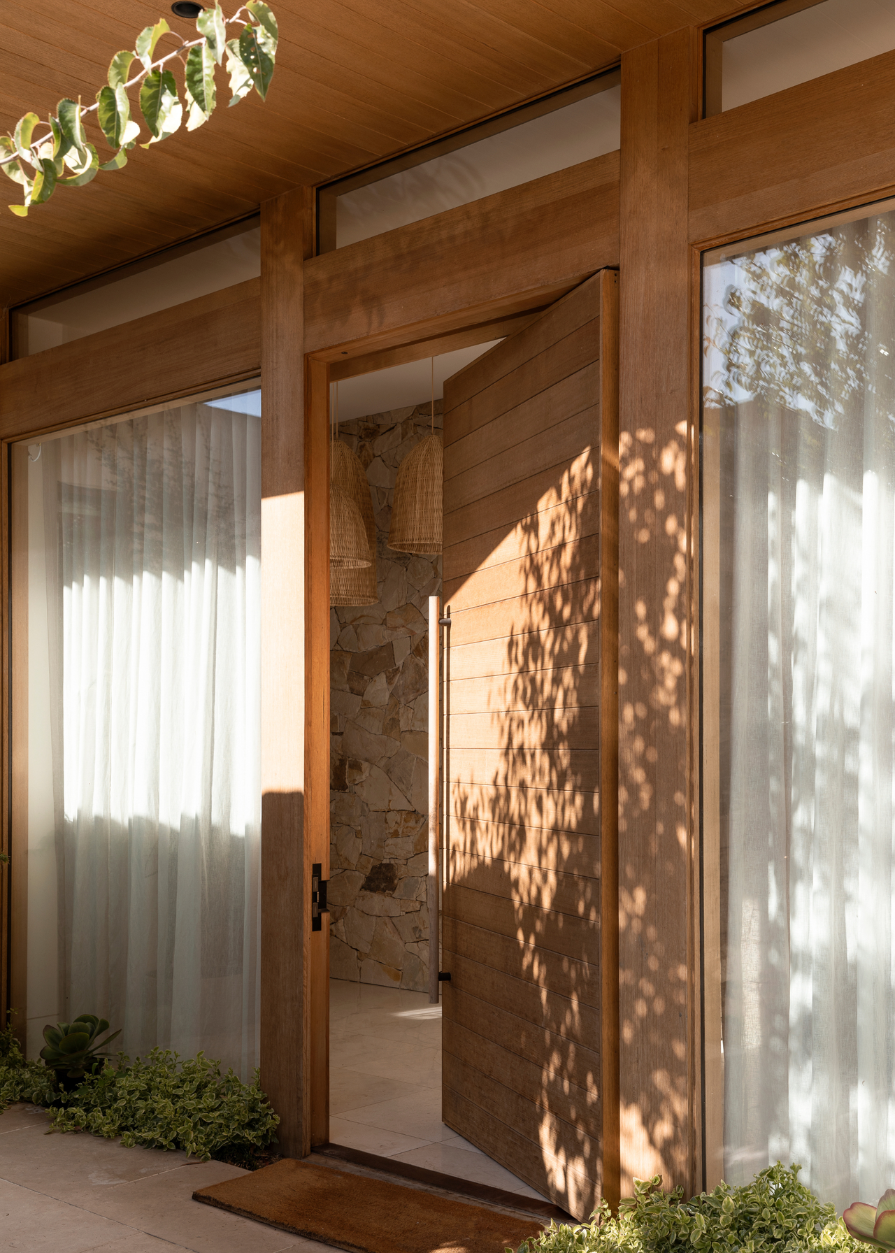 A front door with dappled sunlight