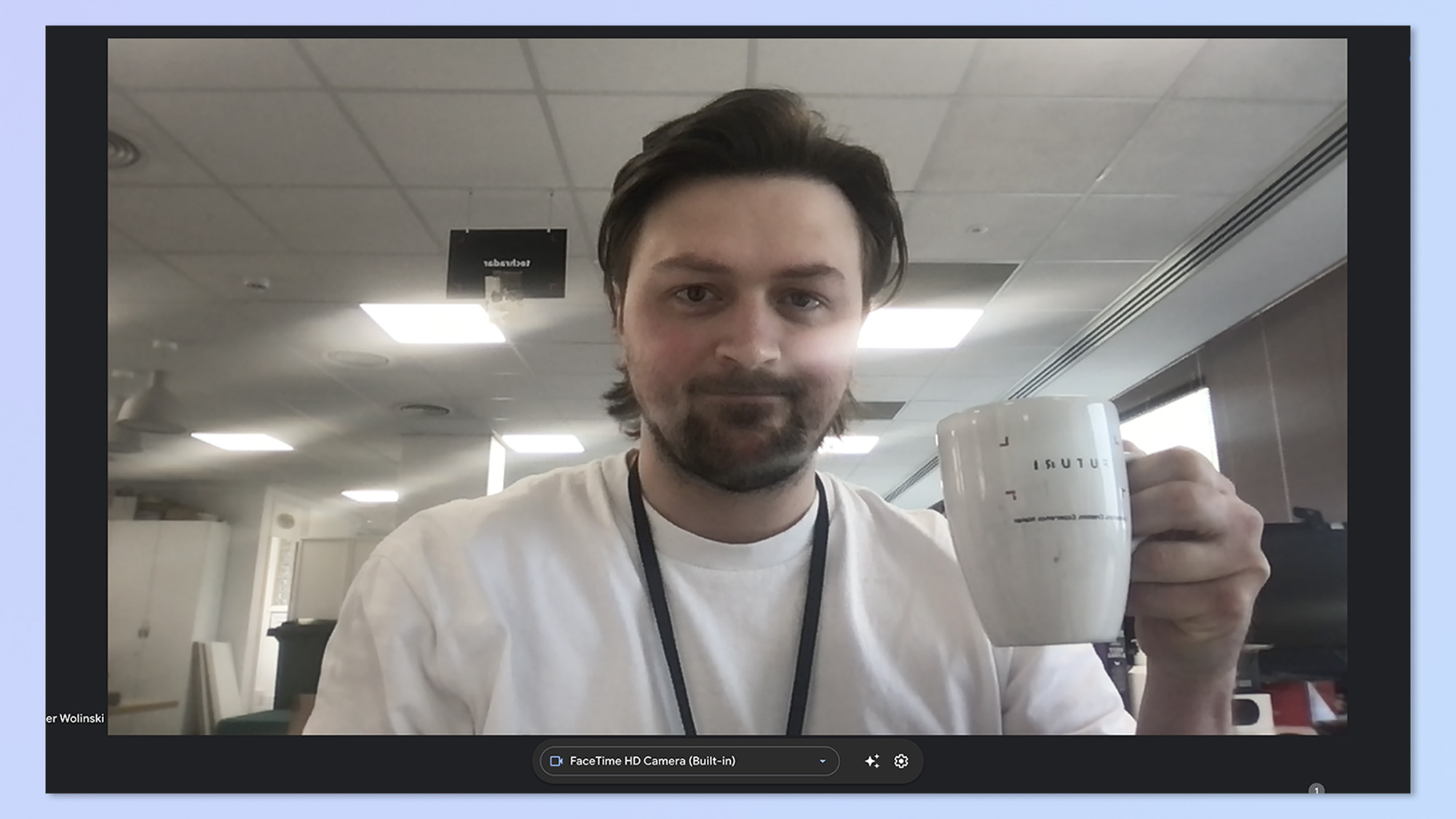 A screenshot of author Peter Wolinski, holding up a mug while on a video call. This screenshot shows the image of the built-in MacBook Pro webcam.