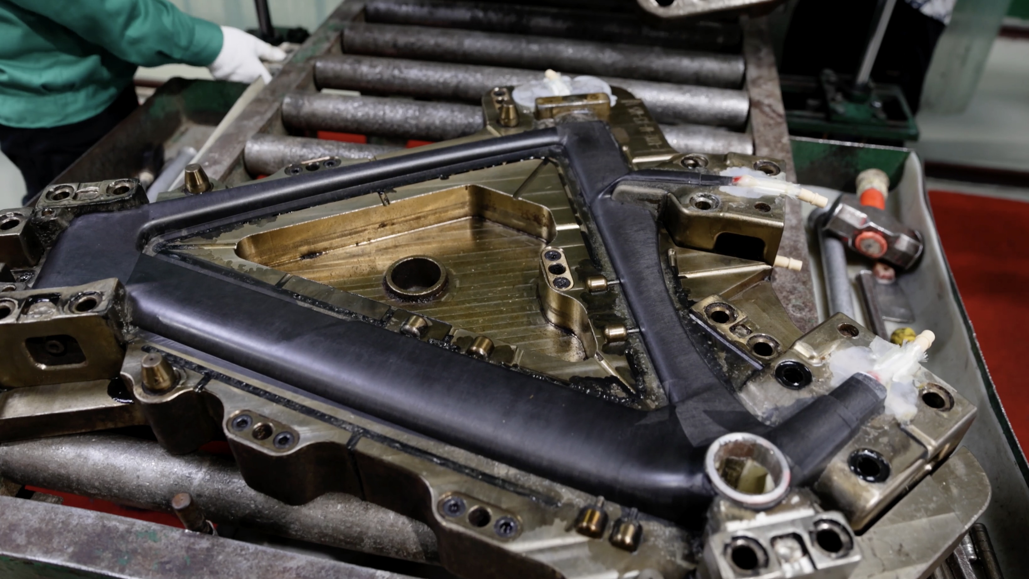 XDS Factory, raw carbon frame being assembled by workers