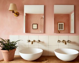 Terracotta painted bathroom with twin sinks and mirrors, natural painted bathroom