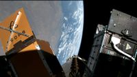 various space probe cubesats are attached to a payload adapter in orbit of Earth.