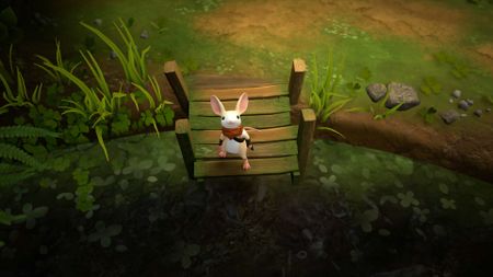 A cute mouse wearing a red sash stands on a short jetty at the edge of a pond.