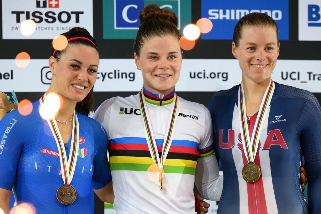 Belgiums Lotte Kopecky C celebrates with her gold medal on the podium flanked by Italys Rachele Barbieri L taking second place silver medal and US Jennifer Valente R taking third place bronze medal after the Womens Elimination finals during the UCI Track Cycling World Championships at the Velodrome of SaintQuentinenYvelines southwest of Paris on October 13 2022 Photo by AnneChristine POUJOULAT AFP Photo by ANNECHRISTINE POUJOULATAFP via Getty Images