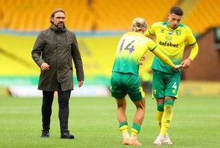 Daniel Farke, left, consoles Todd Cantwell, centre, and Ben Godfrey after the the final whistle on Saturday