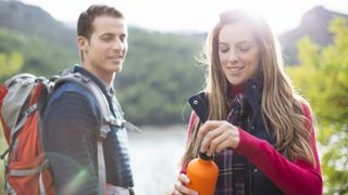 Couple hiking in grassy field