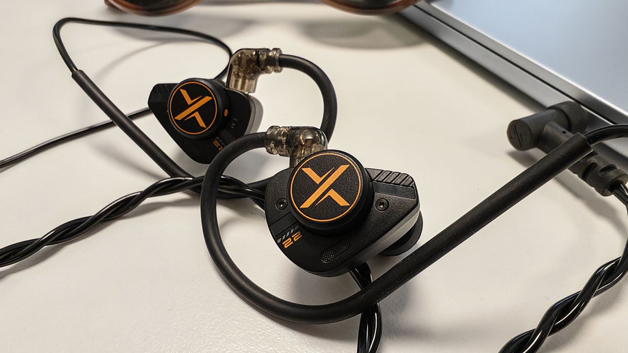 The Ooopus Op.22 earphones on a white desktop.