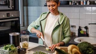 A woman prepares a healthy smoothie