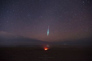 A Geminid fireball blazes through the sky above a campfire at Assateague Island National Seashore in Maryland during the Geminid meteor shower. Astrophotographer Jeff Berkes snapped this photo on Dec. 14, 2018, at 2:30 a.m. local time.