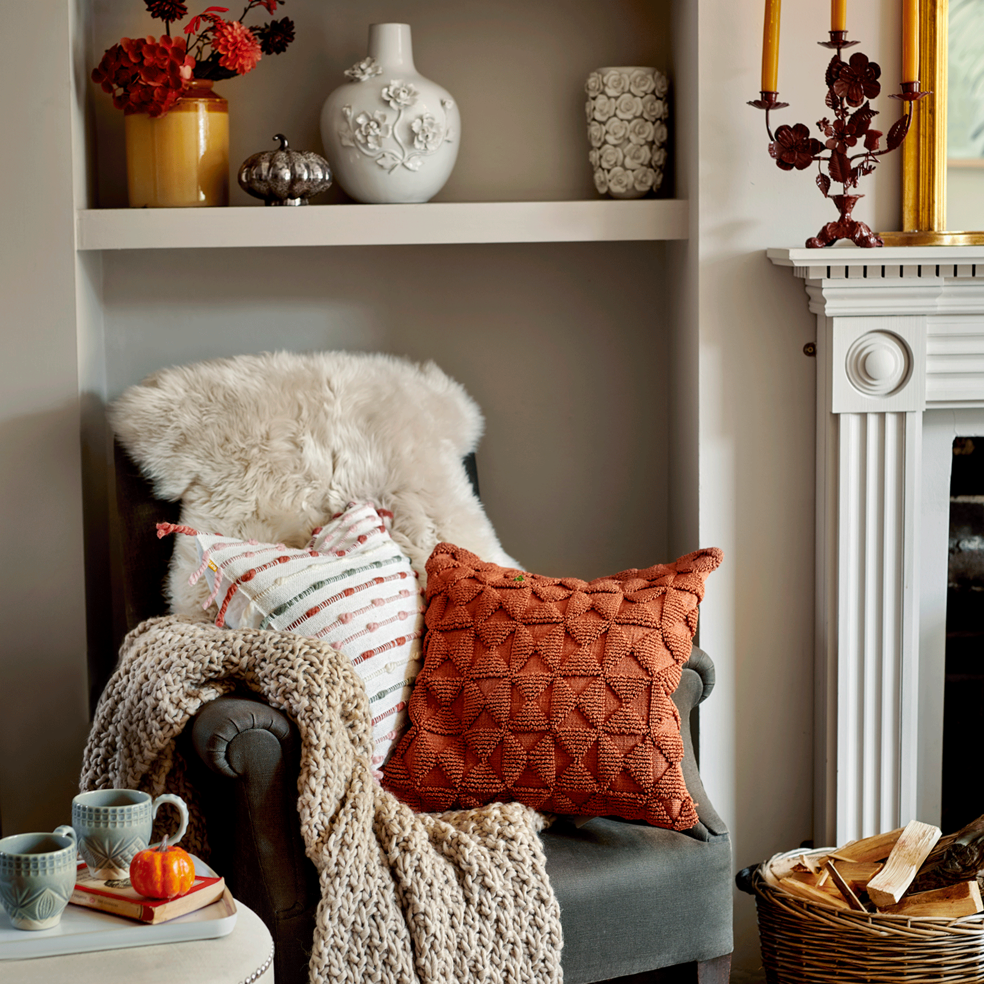 Grey chair with cushions and fur throw