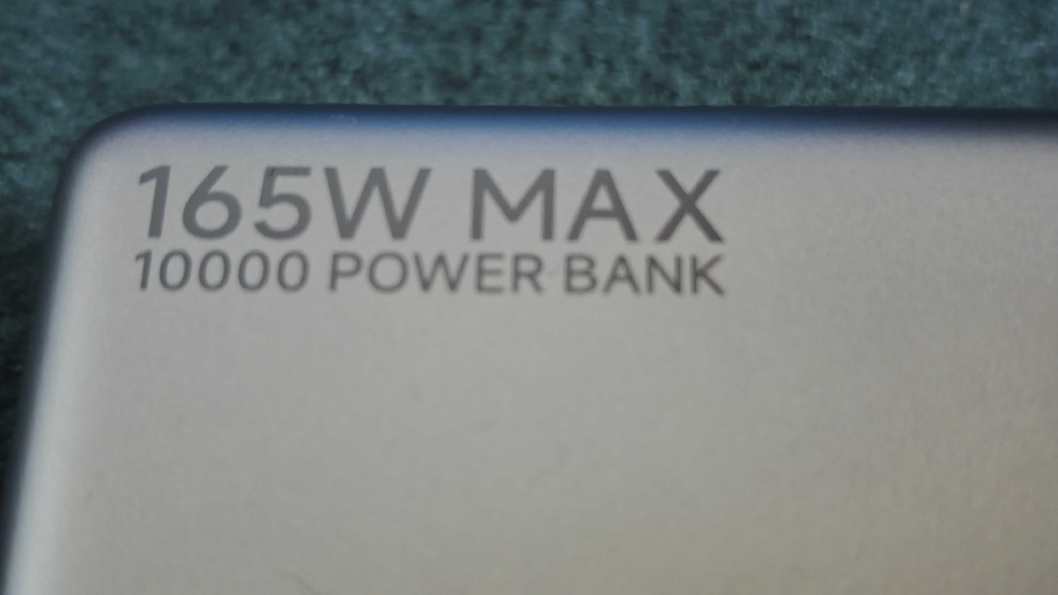A matte grey Xiaomi 165W Power Bank on a green sofa