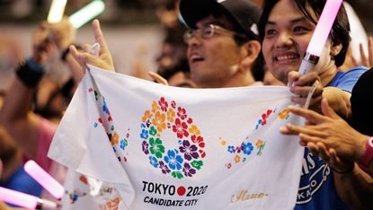 TOKYO, JAPAN - SEPTEMBER 08:Residents of Olympic bid city Tokyo celebrate while holding Tokyo signs after the announcement of the 2020 Summer Olympic Games host city at Komazawa Olympic Park 