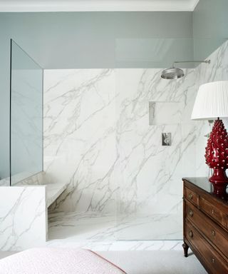 White shower with seat, red lap, wooden cabinet