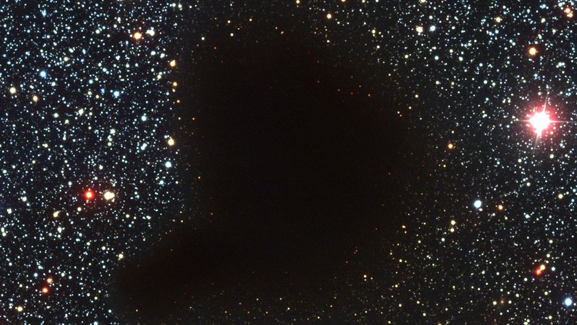 a photograph of starry outer space with a dark blob in the middle