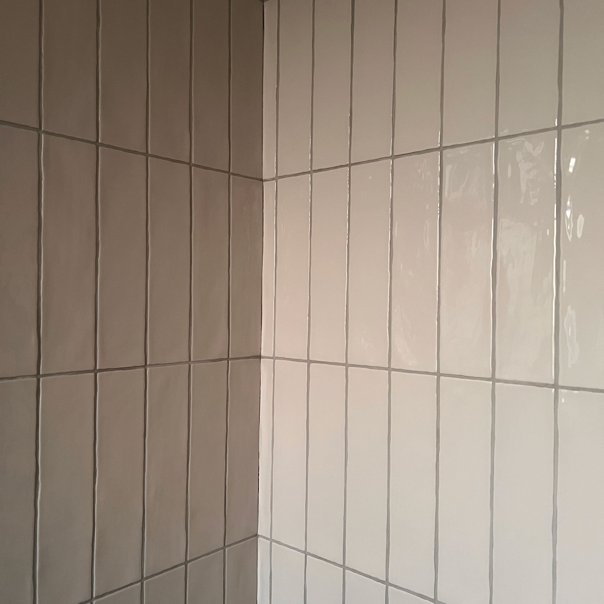 Pale vertical tiles with pale grey grouting