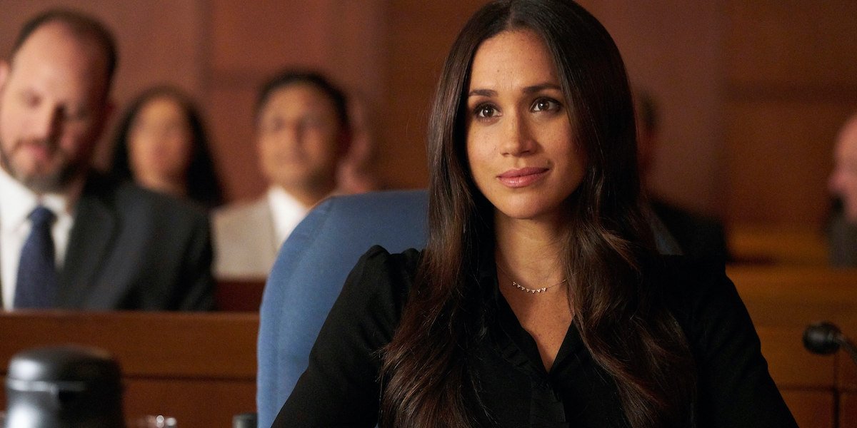 Rachel (Meghan Markle), listens intently from her seat in a court room in &#039;Suits&#039;