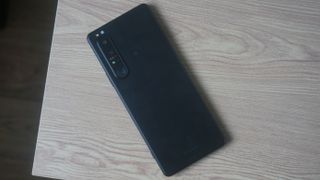 A Sony Xperia 1 III sat face down on a wooden surface