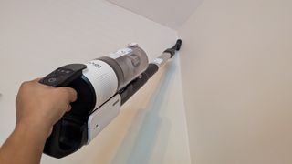 Levoit LVAC-200 cordless vacuum in handheld mode, cleaning in the corner of a room