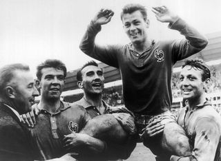 The French player Just FONTAINE who scored 13 goals is held in triumph by his team mates. From left to right : DOUIS, Andre LEROND, Just FONTAINE and Jean VINCENT. France was in the third rank in the World Cup that took place in Stockholm.