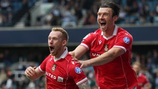 Lewis O'Brien of Wrexham celebrates his goal with Kieffer Moore of Wrexham during the Sky Bet Championship match between Millwall and Wrexham AFC at The Den on August 30, 2025 in London, England.