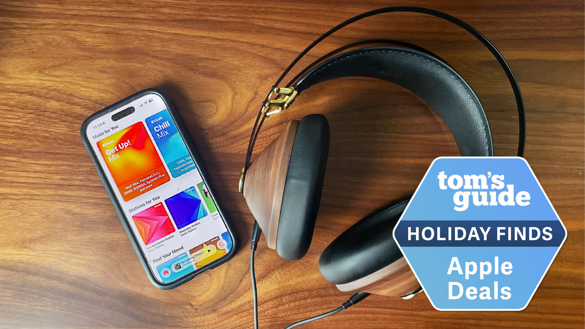 Apple Music shown on iPhone next to headphones