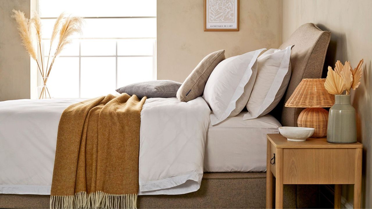 Yellow bedroom with bed dressed in foreground