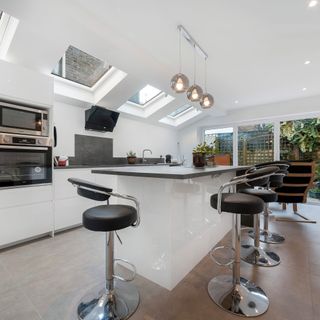 side return kitchen extension with rooflights and large kitchen island with black and chrome bar stools