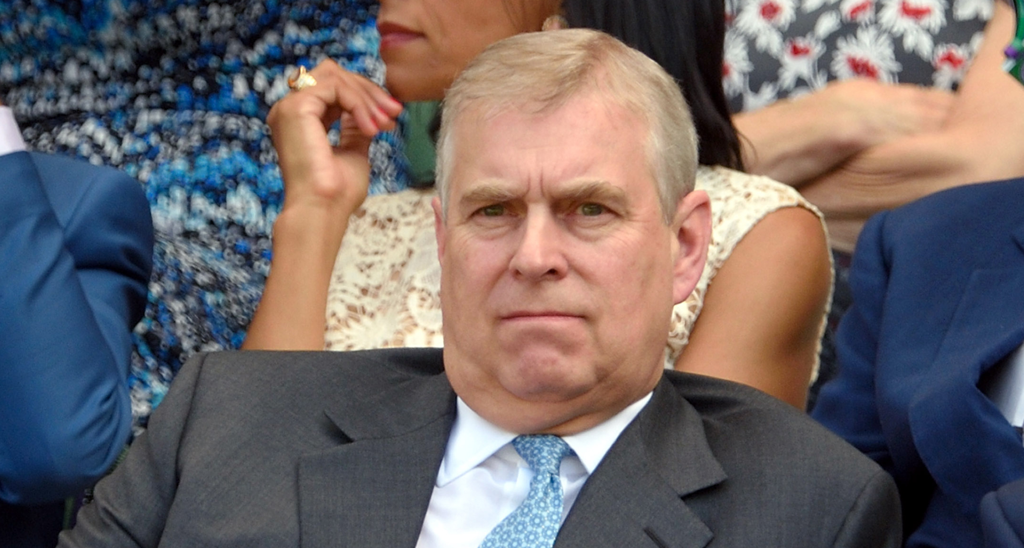 Andrew Mountbatten-Windsor wearing a gray suit and blue tie at Wimbledon