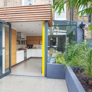 Kitchen diner extension leading out onto patio with raised beds
