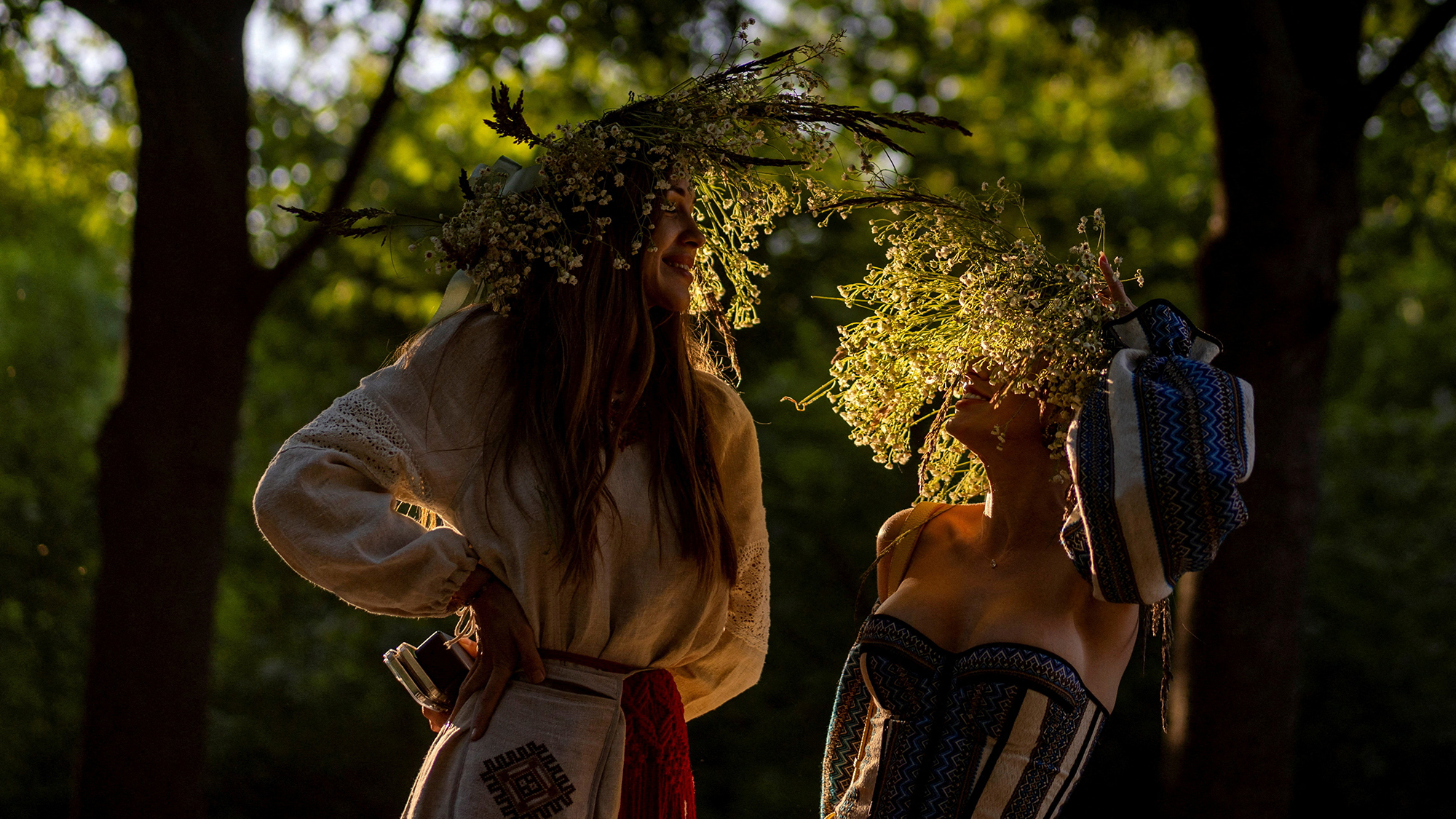 Women wear floral wreaths during Ivana Kupala, an ancient Slavic folk festival associated with the summer solstice, at the Mamayeva Sloboda outdoor museum in Kyiv, Ukraine