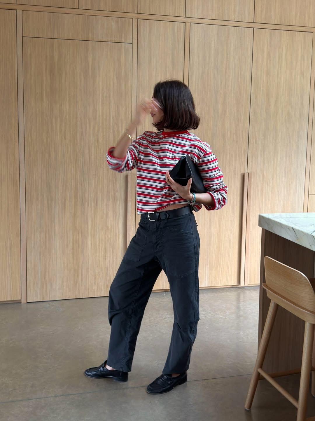 @smythsisters wearing striped long-sleeve, black jeans, and loafers