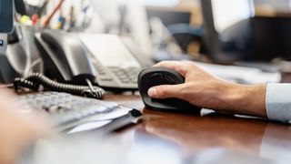 An office worker using an ergonomic mouse