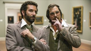 (L-R) Bradley Cooper as Richie DiMaso and Christian Bale as Irving Rosenfeld in "American Hustle" currently streaming on Netflix