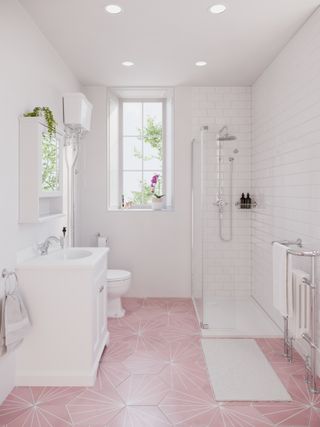white wall tiles and a pink floor tiles in a small bathroom