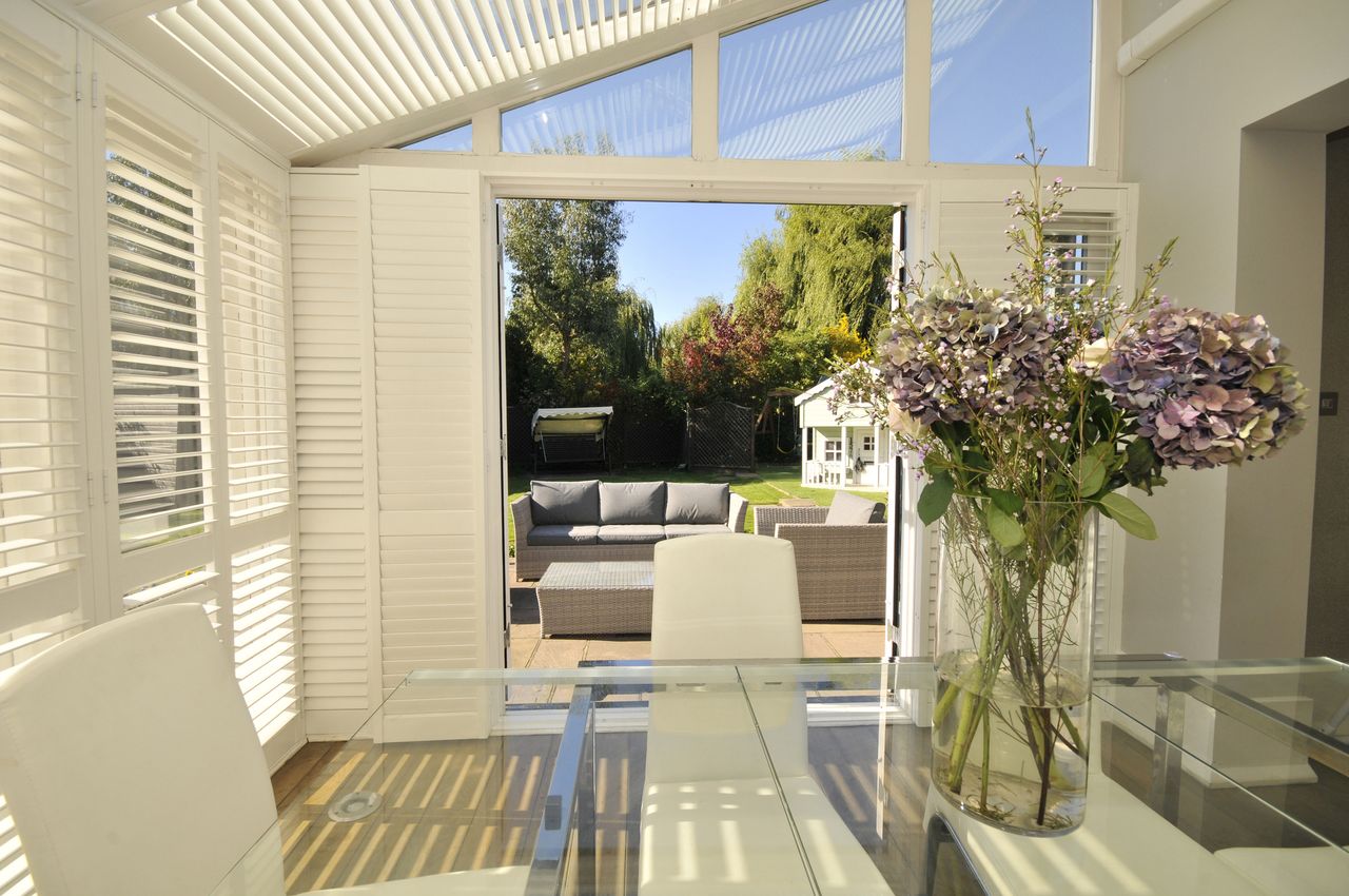 Window shades and awning used to cool sunny room in house