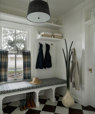 mud room with black and white tiled floor and bench seat and onion hat stand