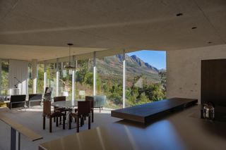 Living space with floor to ceiling windows in Mountain House in South Africa