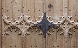 Close up of Hand-carved oak gothic doors